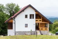 a white house with a gambrel roof at Apartment Stone and Wood in Cetingrad