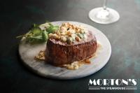 a plate with a piece of food on a table at HoteLumiere at the Arch, A Caesars Destination in Saint Louis