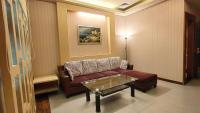 a living room with a couch and a table at Jin Yong Quan Spa Hotspring Resort in Wanli District