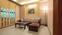a living room with a couch and a table and a lamp at Jin Yong Quan Spa Hotspring Resort in Wanli District