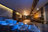 a row of blue dishes on a bar in a restaurant at Hotel Millennium Inn, Prayagraj in Allahābād