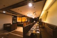 a dining room with a long line of tables at Hotel Millennium Inn, Prayagraj in Allahābād