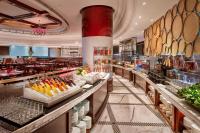 a restaurant with a buffet line with food at The Ritz-Carlton, Guangzhou in Guangzhou