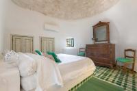 Posteľ alebo postele v izbe v ubytovaní Trulli Il Cappero by Perle di Puglia