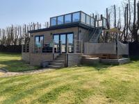 a house with a glass facade with a spiral staircase at Le Theven in Sibiril