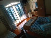 a bedroom with a bed and a large window at Pousada Colina Da Neve in São Joaquim