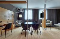 a living room with a dining room table and chairs at Le Méridien Vienna in Vienna