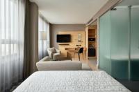 a hotel room with a bed and a desk at Le Méridien Vienna in Vienna