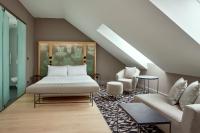 a bedroom with a bed and a couch at Le Méridien Vienna in Vienna