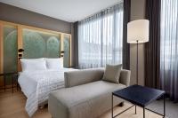 a bedroom with a bed and a couch and a chair at Le Méridien Vienna in Vienna