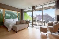 a bedroom with a bed and two chairs at Le Méridien Vienna in Vienna