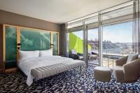 a bedroom with a bed and a large window at Le Méridien Vienna in Vienna