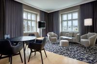 a living room with a table and chairs at Le Méridien Vienna in Vienna