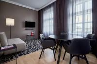 a living room with a table and chairs at Le Méridien Vienna in Vienna