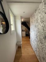 a hallway with a wall mural and a chair at Petit maison avec terrasse proche de Rouen 1h30 de Paris in Bihorel