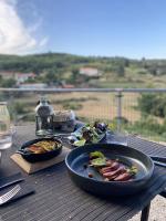 een tafel met een bord eten op een tafel bij Cottage - La Maison du Château - By DOMAINE RIBERACH in Bélesta