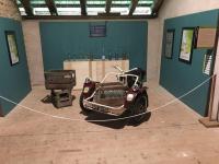 a car on display in a room with a rope at chez Gaby 