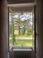 a window with a radiator and a view of a field at La maison du pech in Monteils
