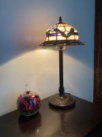 a lamp sitting on a table next to a vase at La maison du pech in Monteils