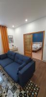 a living room with a blue couch and a mirror at El Dar in Cholet