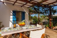 a table set for a meal on the patio of a house at Villa in the Garden in Kokkini Khanion