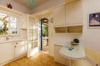 a kitchen with a sink and a table in a room at Villa in the Garden in Kokkini Khanion