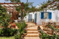 a garden with a pergola and a table with flowers at Villa in the Garden in Kokkini Khanion
