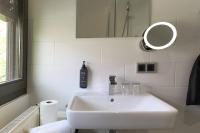 a white bathroom with a sink and a mirror at Hotel Rhönkitz in Bad Kissingen