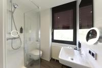 a bathroom with a shower and a sink and a mirror at Hotel Rhönkitz in Bad Kissingen