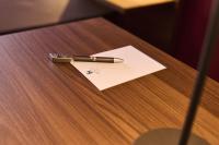 a pen sitting on top of a paper on a table at Hotel Rhönkitz in Bad Kissingen