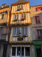 a yellow and white building with windows and flowers at Ty Kaz Old Kemper in Quimper