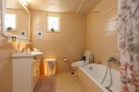 a bathroom with a tub and a toilet and a sink at Villa in the Garden in Kokkini Khanion