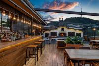 a restaurant with a bar and a fireplace at IOTA Hotel Tbilisi in Tbilisi City