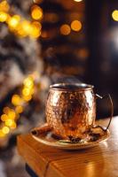 a gold coffee cup on a plate on a table at IOTA Hotel Tbilisi in Tbilisi City