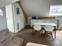 a living room with a table and chairs at Charmant appartement chez Pat in Caen