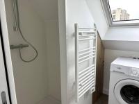 a bathroom with a washing machine and a window at Charmant appartement chez Pat in Caen