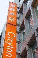 an orange sign in front of a building at Cityinn Hotel Taipei Station Branch I in Taipei