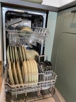 a dishwasher filled with lots of hot dogs and pans at L’escale 175 in Divatte sur Loire