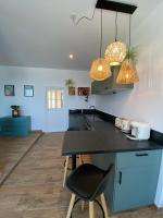 a kitchen with blue cabinets and a black counter top at L’escale 175 in Divatte sur Loire