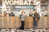 a man and a woman standing at a counter at Wombat&#39;s City Hostel London in London