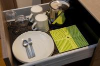 a table with a plate and utensils in a drawer at Tokyu Stay Kyoto Sanjo-Karasuma in Kyoto