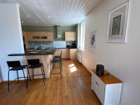 a kitchen with a island and chairs in a room at Le logis des Halles in Cerizay