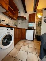 a kitchen with a washing machine in a kitchen at #Le Rue des 2 Porches #F2 avec Cours #HyperCentre in Brive-la-Gaillarde