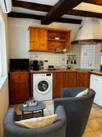 a kitchen with a couch and a washing machine at #Le Rue des 2 Porches #F2 avec Cours #HyperCentre in Brive-la-Gaillarde