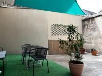 a patio with a table and chairs and plants at #Le Rue des 2 Porches #F2 avec Cours #HyperCentre in Brive-la-Gaillarde