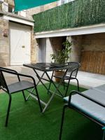 a table and chairs on a patio with green grass at #Le Rue des 2 Porches #F2 avec Cours #HyperCentre in Brive-la-Gaillarde