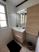 a bathroom with a sink and a mirror at #Le Rue des 2 Porches #F2 avec Cours #HyperCentre in Brive-la-Gaillarde