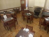 an overhead view of a restaurant with tables and a fireplace at The Border Post, Bed and Breakfast in Bergville