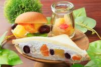 a plate with a sandwich and a jar of fruit salad at QuintessaHotel FukuokaHakata Relax&Sleep in Fukuoka
