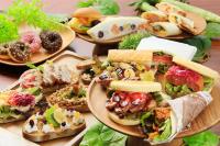 a table topped with plates of sandwiches and other foods at QuintessaHotel FukuokaHakata Relax&Sleep in Fukuoka